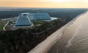 Nowo otwarty hotel nad morzem, z basenem i widokiem na plażę i las. Architektura przypomina schody.
