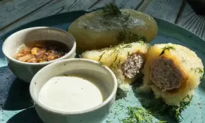 Litewskie cepeliny z mięsem, podane z sosem grzybowym i śmietaną. Pyszne litewskie jedzenie.