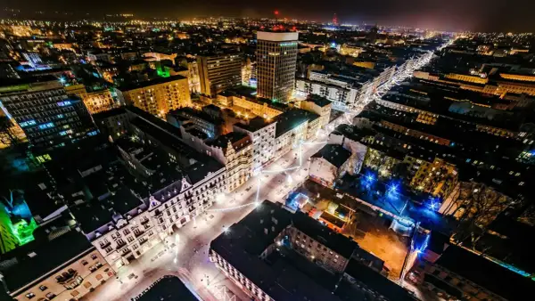 Nocny widok na najdłuższy deptak w Polsce, rozświetlony iluminacjami i światłami miasta.